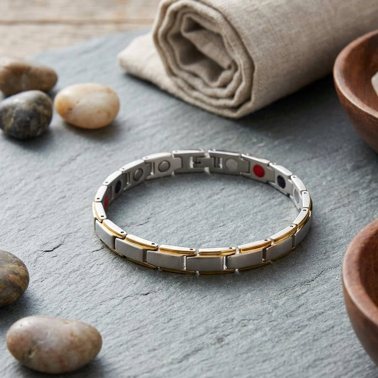 Bracelet with engraved text on a gray surface with stones and a cloth