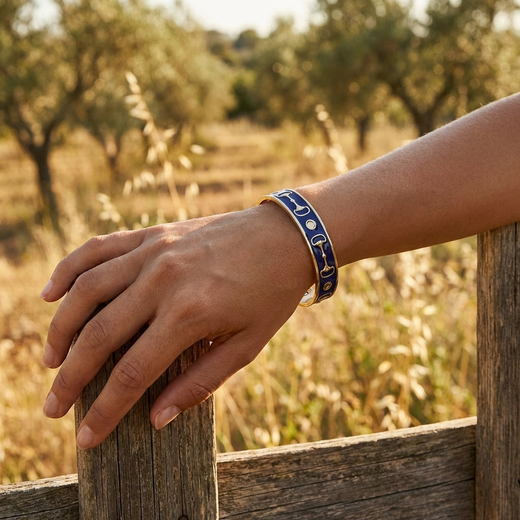 Hand wearing a blue bracelet on a wooden fence with a blurred natural background